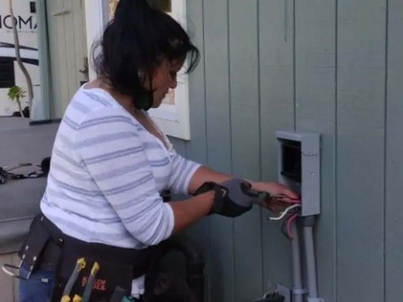 Licensed electrician wiring an exterior subpanel in Bethel Acres